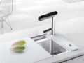 IonPlus UD3000 stainless steel faucet installed on a kitchen sink, part of the undersink alkaline water ionizer system.